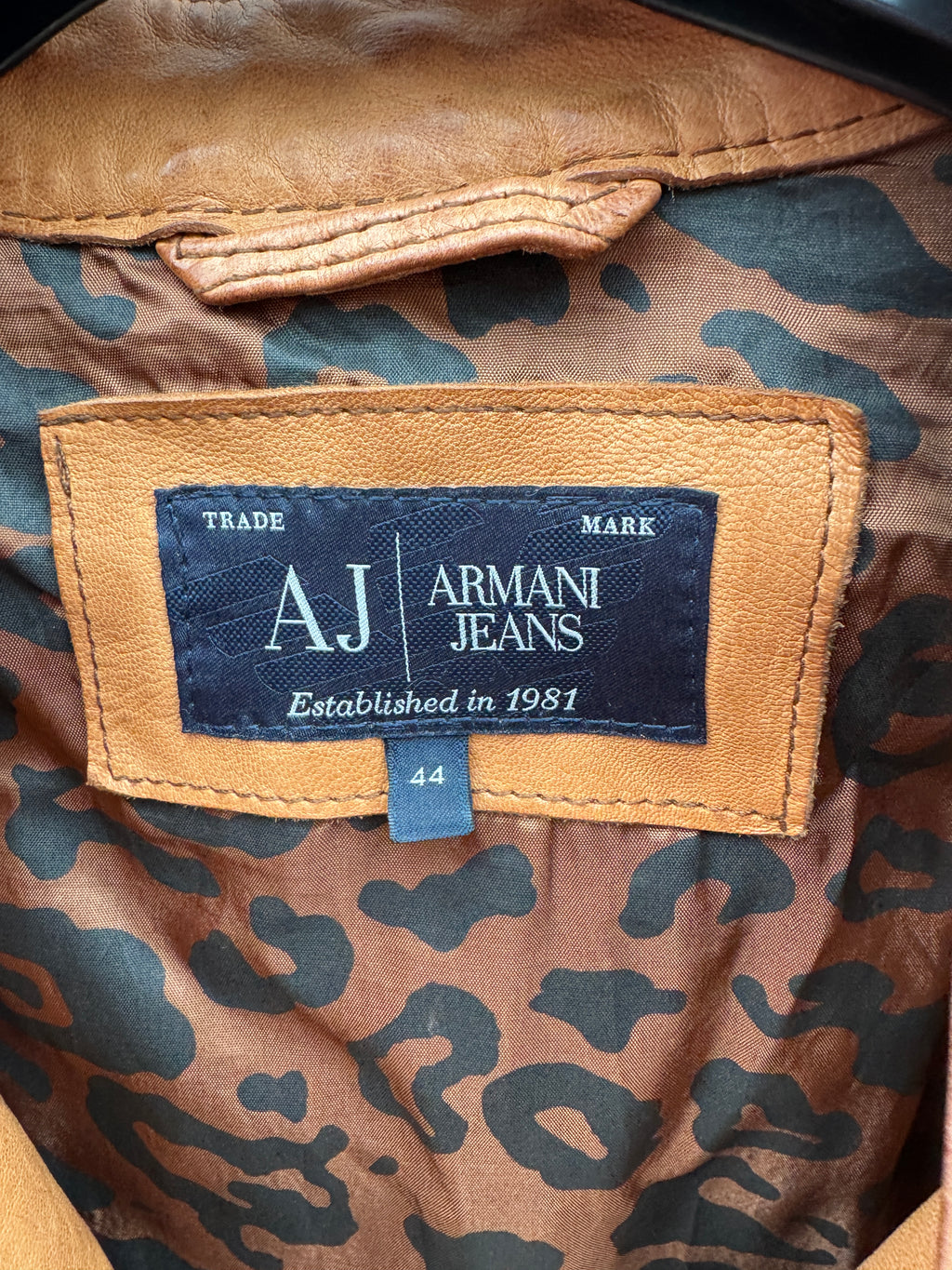 Armani Jeans label on a patterned fabric background