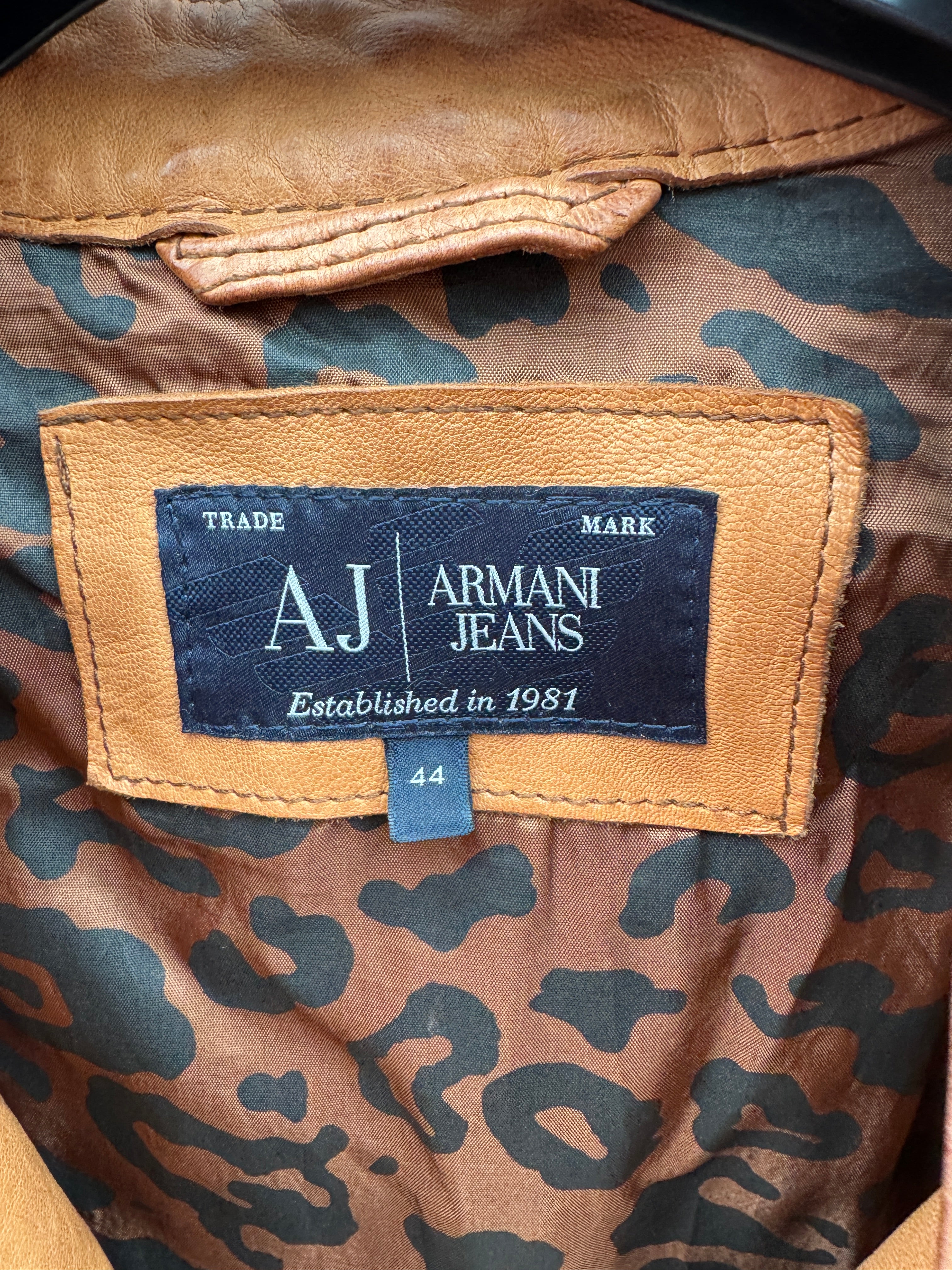Armani Jeans label on a patterned fabric background